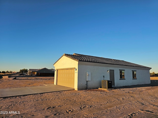 exterior space featuring central AC and a garage