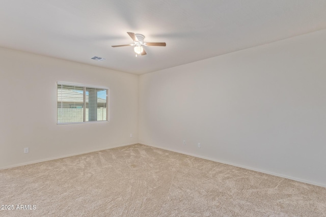 empty room featuring light carpet and ceiling fan