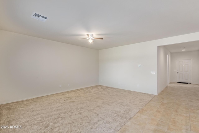 carpeted empty room featuring ceiling fan