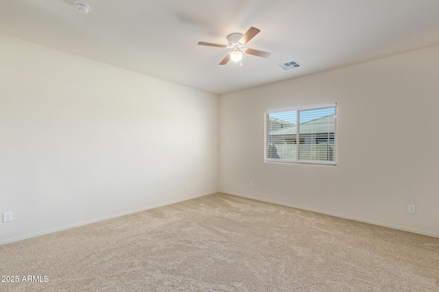 unfurnished room featuring light carpet and ceiling fan