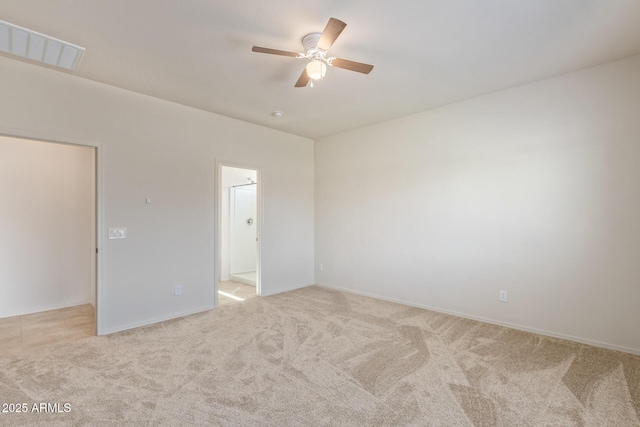 carpeted spare room featuring ceiling fan