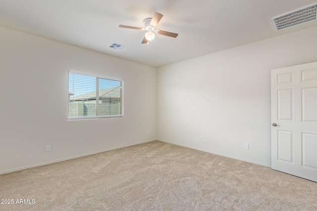 unfurnished room featuring light carpet and ceiling fan