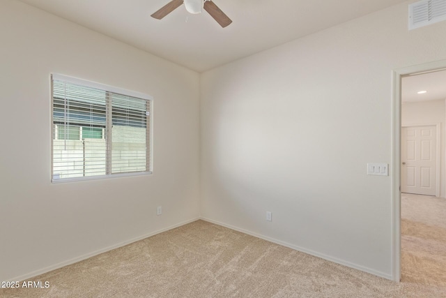 carpeted spare room featuring ceiling fan