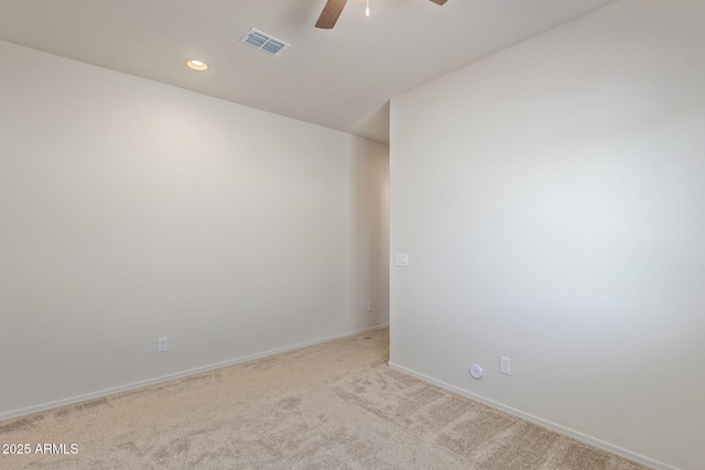 carpeted spare room with ceiling fan