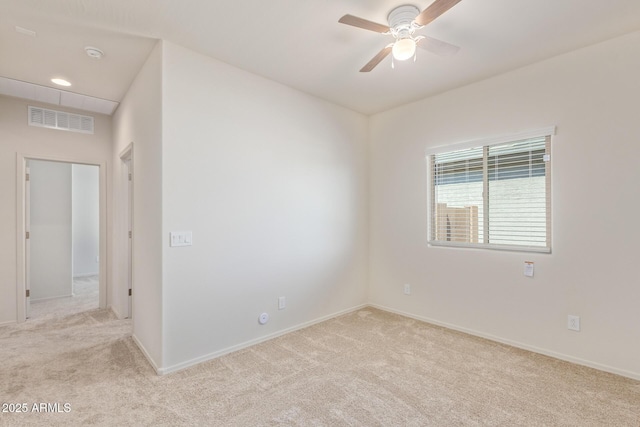 spare room with light carpet and ceiling fan