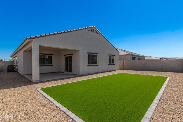 rear view of property featuring a patio area and central AC