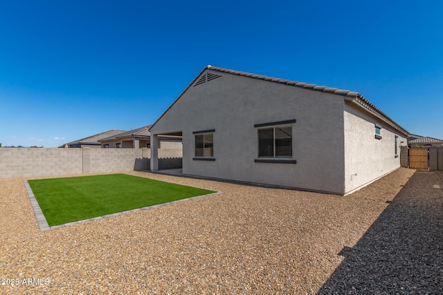 back of property with a patio area and a yard