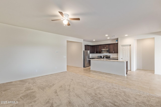 unfurnished living room with light colored carpet and ceiling fan