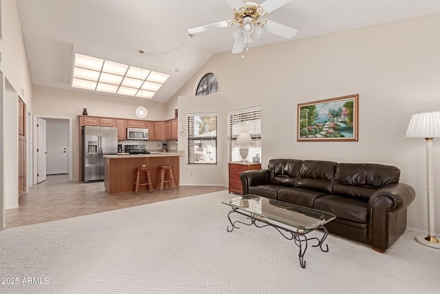 tiled living room with ceiling fan and high vaulted ceiling