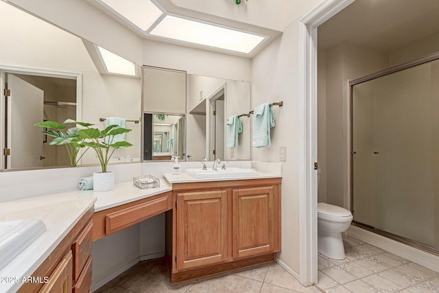 bathroom featuring vanity, a shower with door, and toilet