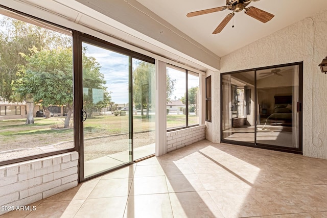 unfurnished sunroom featuring lofted ceiling and ceiling fan