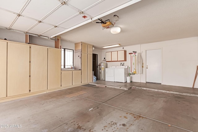 garage with independent washer and dryer, a garage door opener, and water heater