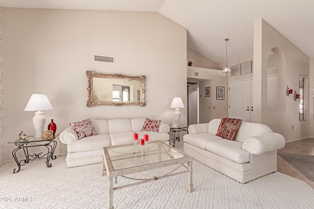 tiled living room featuring high vaulted ceiling