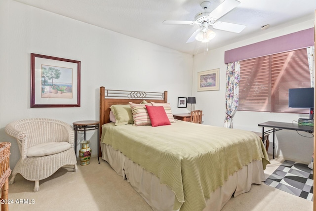 bedroom featuring light colored carpet and ceiling fan