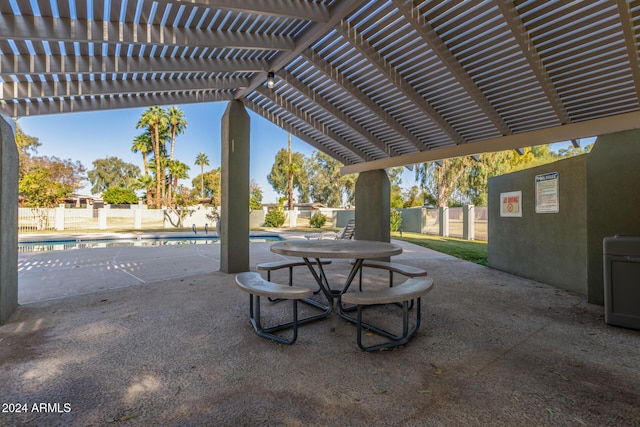 view of patio with a community pool and a pergola