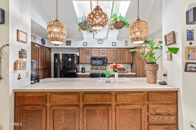 kitchen with lofted ceiling, decorative light fixtures, a chandelier, and black appliances