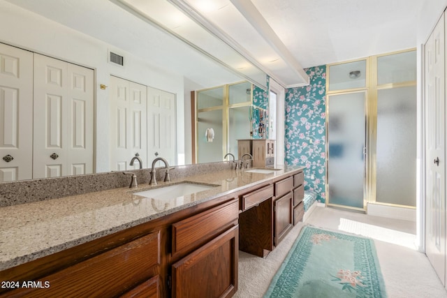 bathroom featuring vanity and an enclosed shower