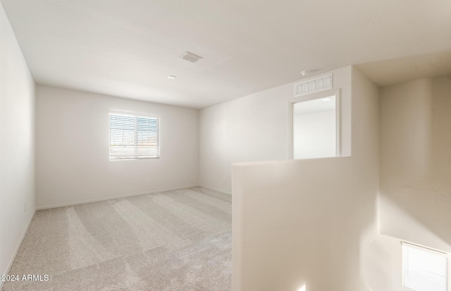 unfurnished room with light carpet