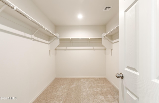 spacious closet featuring light carpet