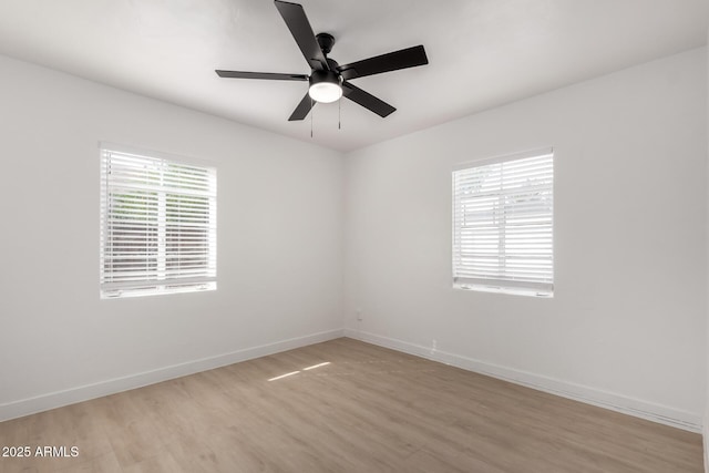 empty room with a ceiling fan, baseboards, and light wood finished floors