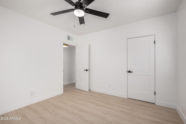 unfurnished bedroom with ceiling fan, baseboards, visible vents, and light wood-type flooring