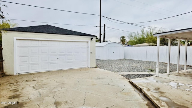 detached garage featuring fence