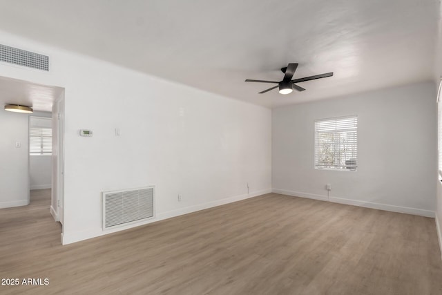 unfurnished room featuring visible vents, baseboards, a ceiling fan, and wood finished floors