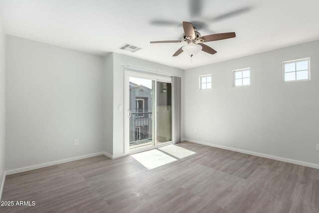 spare room featuring light hardwood / wood-style flooring and ceiling fan