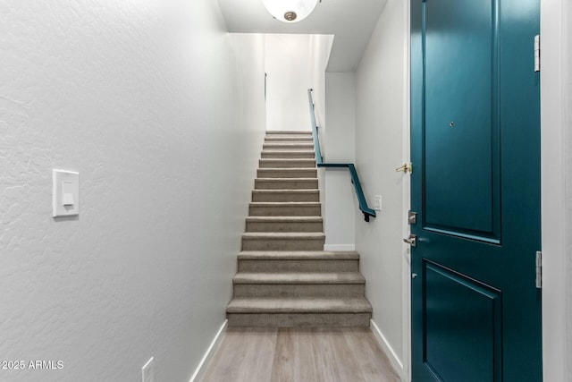 stairway featuring hardwood / wood-style flooring