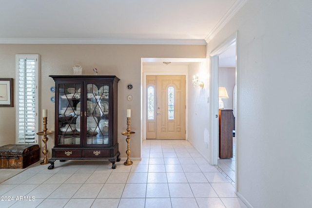 tiled foyer entrance with ornamental molding