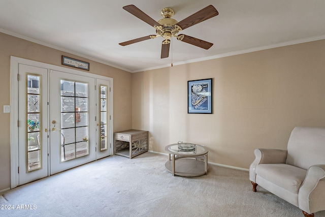 living area with light colored carpet, ceiling fan, and crown molding