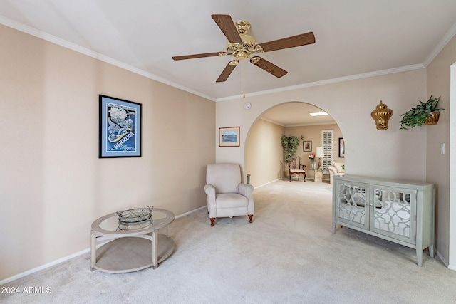 sitting room with light colored carpet, ceiling fan, and crown molding