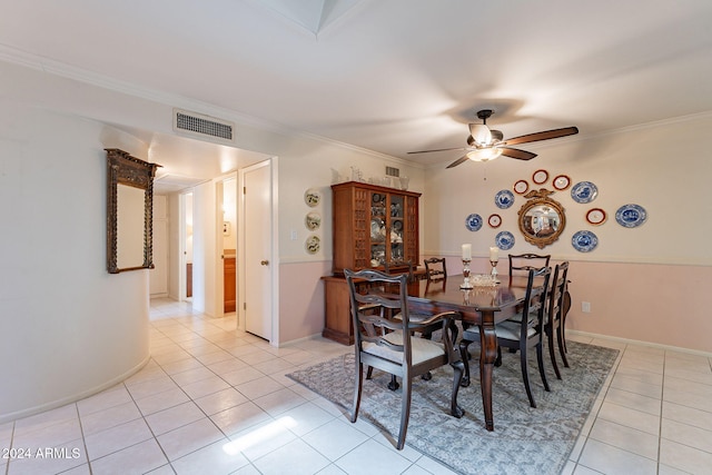 dining area with ceiling fan, light tile patterned floors, and crown molding