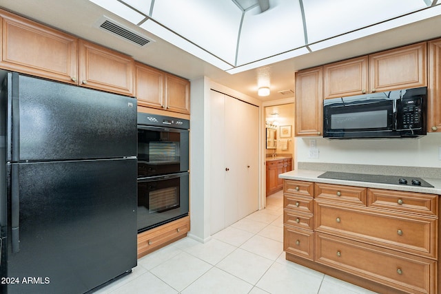 kitchen with black appliances and light tile patterned floors