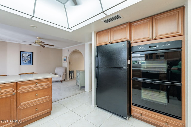 kitchen with black appliances, ceiling fan, light tile patterned floors, and crown molding