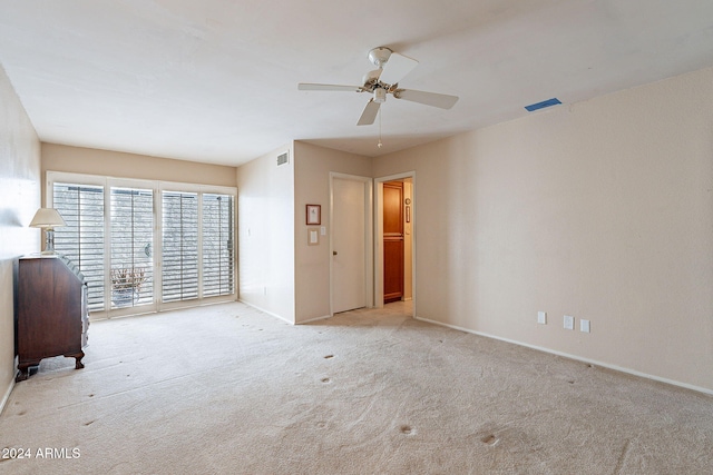 interior space with light carpet and ceiling fan