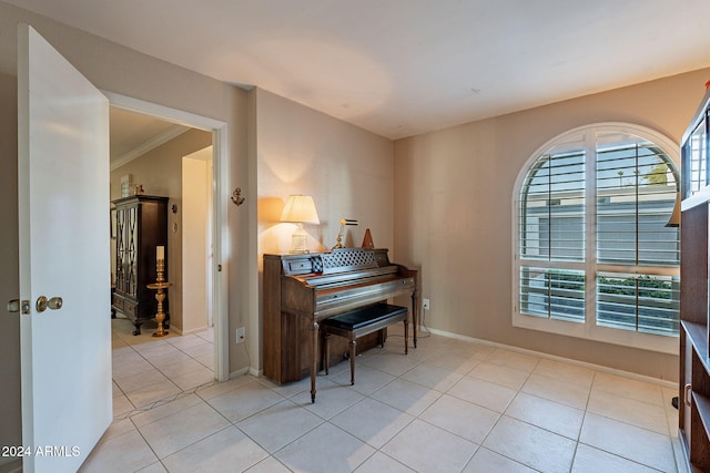 miscellaneous room featuring light tile patterned floors and crown molding