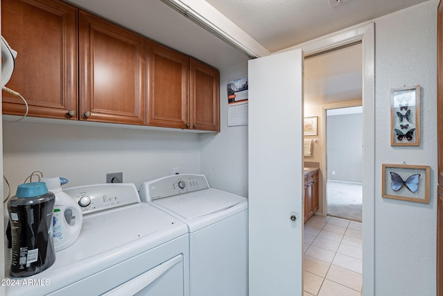 washroom featuring light tile patterned floors, cabinets, and independent washer and dryer