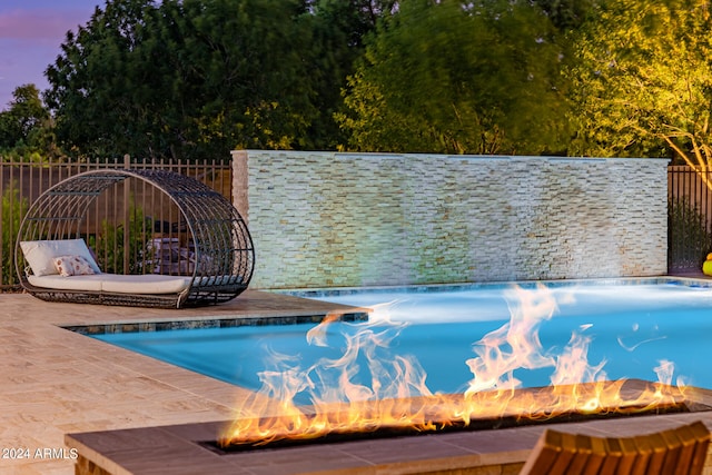 view of pool with an outdoor fire pit