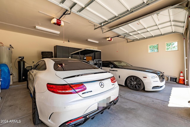 garage with water heater and a garage door opener