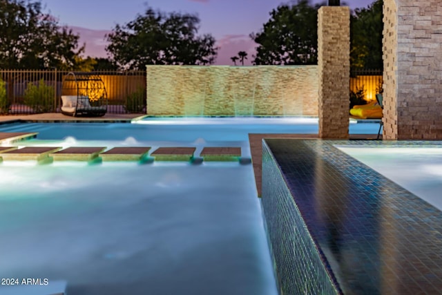 view of pool with a fenced in pool and fence