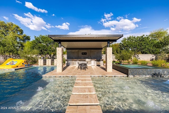 view of patio featuring an in ground hot tub, area for grilling, fence private yard, and a fenced in pool