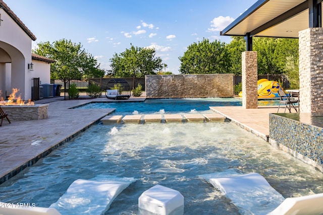 view of swimming pool with a fire pit, an outdoor hot tub, fence, and a patio