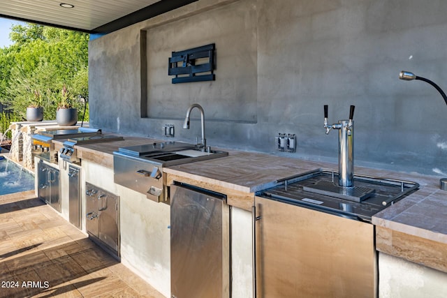 exterior space with tile countertops and fridge