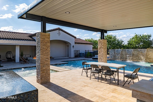 view of patio with fence and an outdoor pool