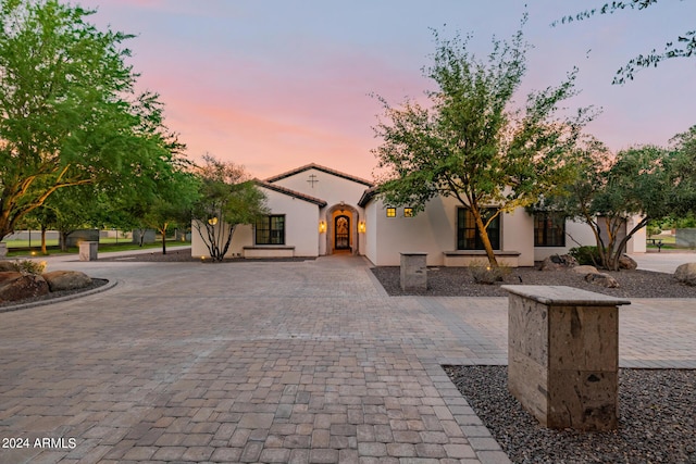 mediterranean / spanish-style home featuring decorative driveway and stucco siding