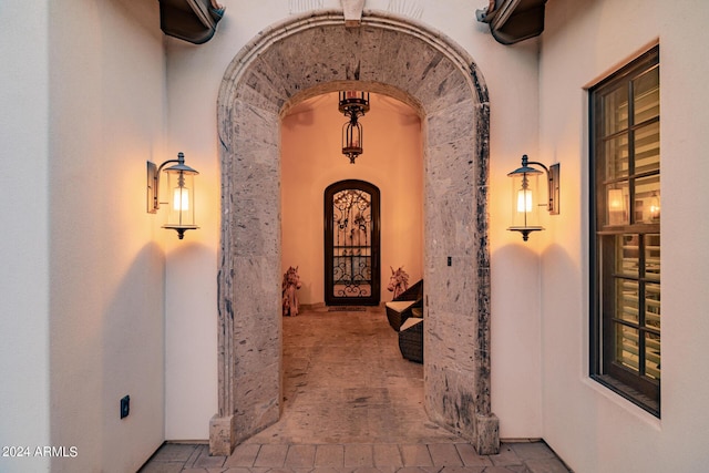 hallway featuring arched walkways