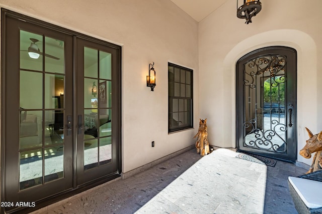 view of exterior entry with stucco siding and french doors