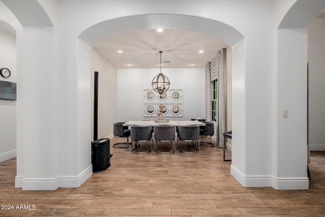 dining space with baseboards, a chandelier, wood finished floors, and recessed lighting