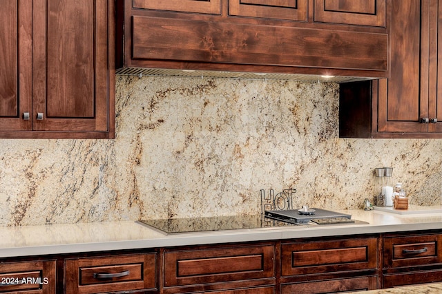 kitchen featuring dark brown cabinets, custom exhaust hood, and light countertops